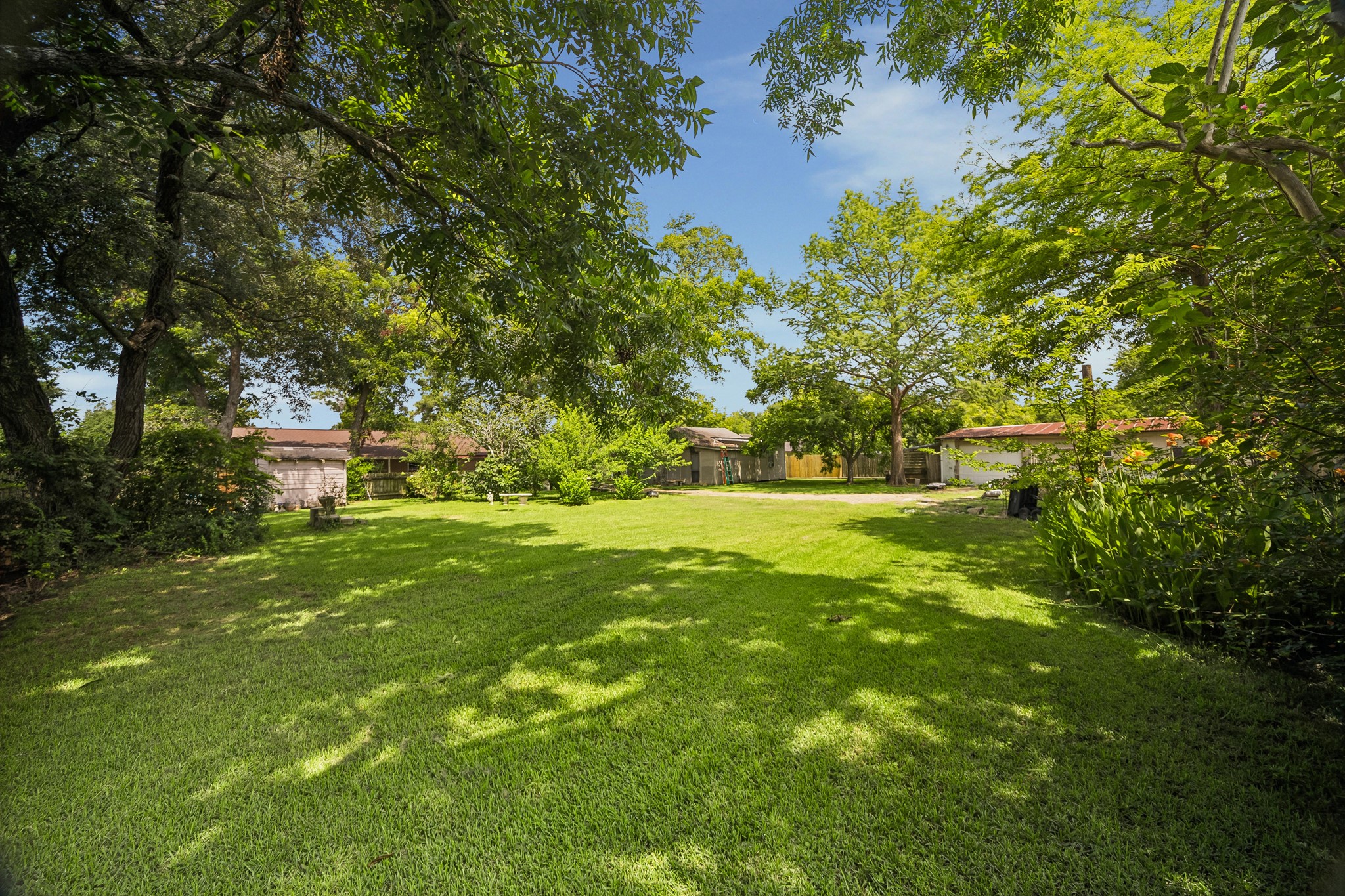 413 Mebane Lane Rosenberg, TX 77471 - Photo 27 of 30 Spacious backyard with well-maintained lawn, surrounded by mature trees providing ample shade and privacy. Ideal for outdoor activities and relaxation.
