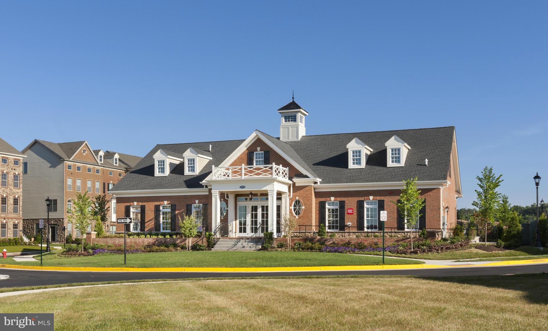 22595 Windsor Locks Square Ashburn, VA 20148 - Photo 11 of 13 a front view of a residential apartment building with a yard
