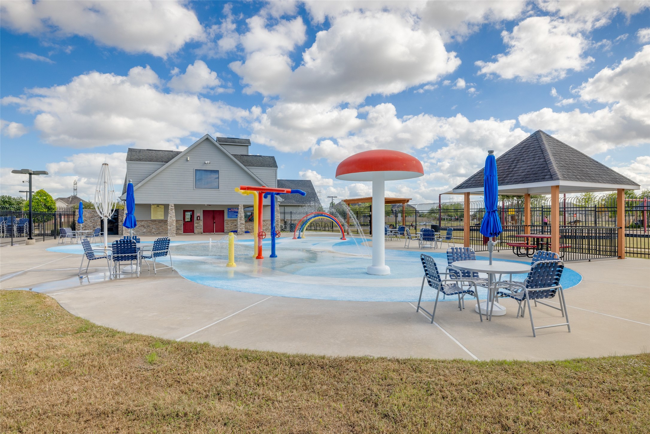 2515 Night Emerald Drive Rosharon, TX 77583 - Photo 22 of 30 a patio with a table and chairs under an umbrella