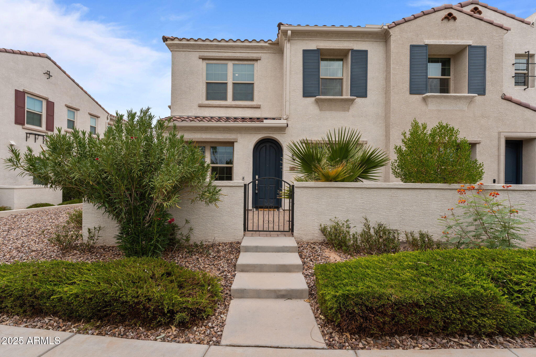 4077 South Sabrina Drive, Unit 127 Chandler, AZ 85248 - Photo 1 of 46 a front view of a house with a garden
