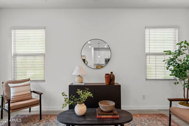 a bathroom with a granite countertop sink a toilet a large mirror and shower
