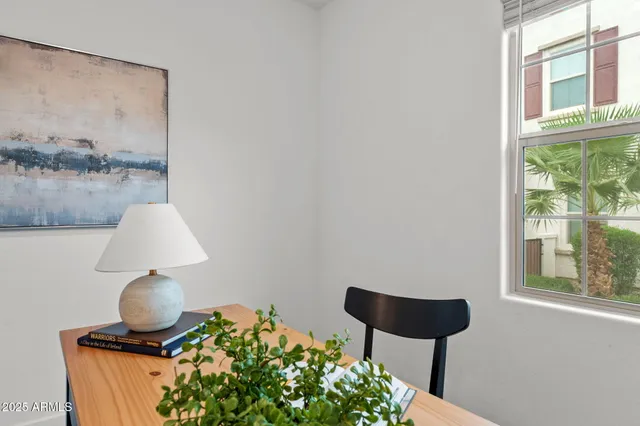 a front view of a house with a yard and potted plants