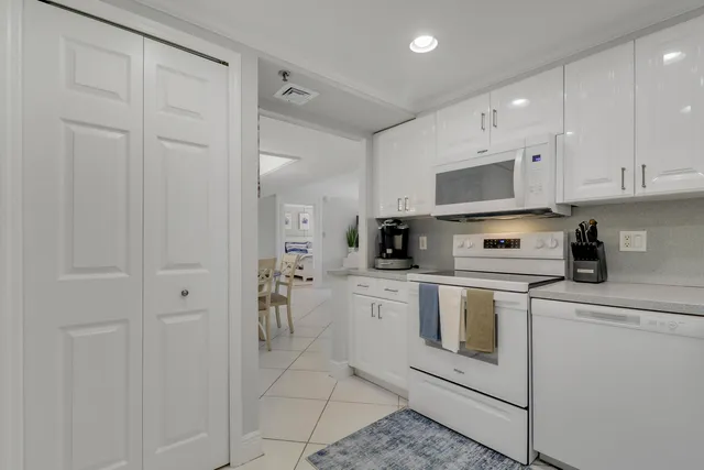 a kitchen with cabinets appliances and a sink