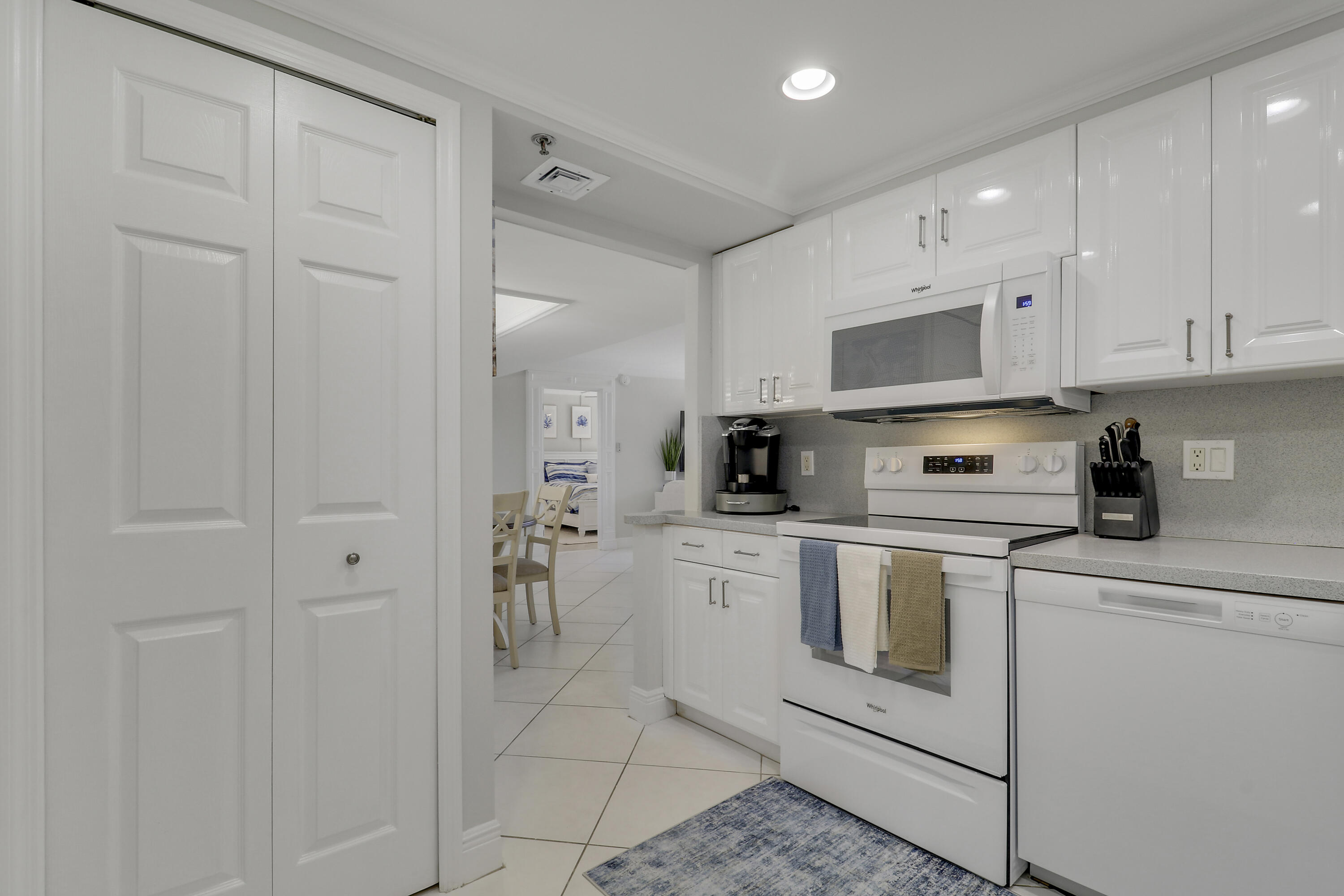 200 Ocean Trail Way, Unit 407 Jupiter, FL 33477 - Photo 17 of 22 a kitchen with cabinets stainless steel appliances and sink