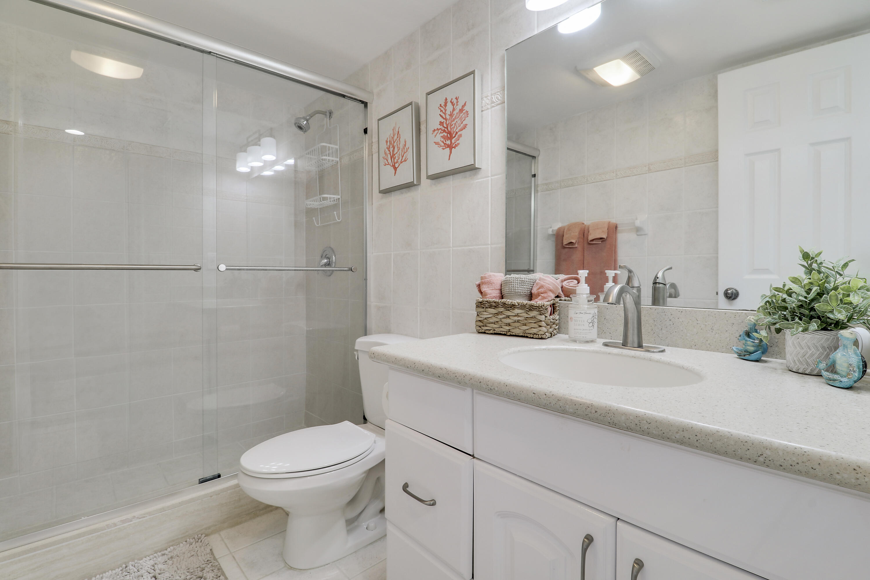 200 Ocean Trail Way, Unit 407 Jupiter, FL 33477 - Photo 19 of 22 a bathroom with a sink a toilet and shower