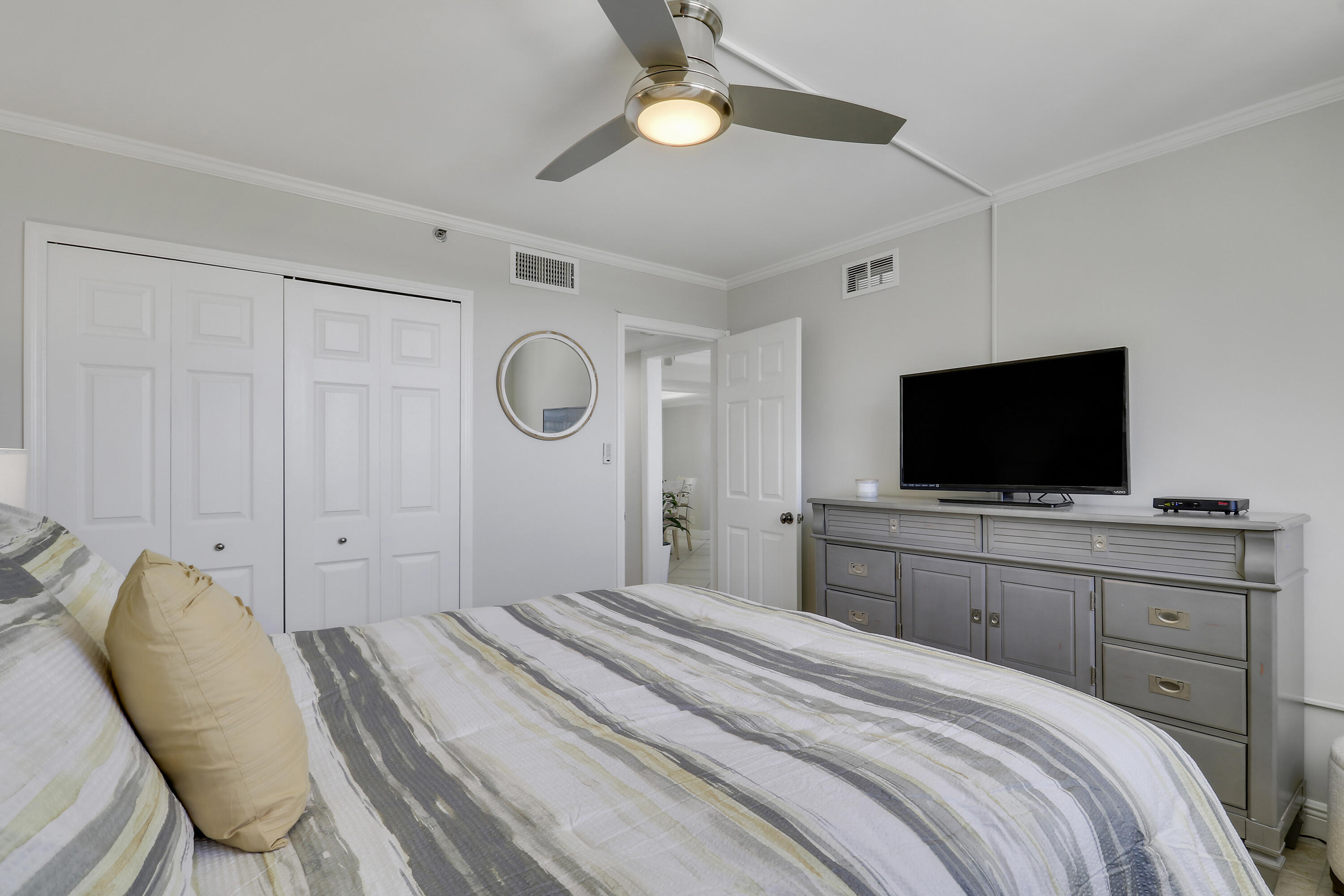 200 Ocean Trail Way, Unit 407 Jupiter, FL 33477 - Photo 21 of 22 a bedroom with a bed and a flat screen tv