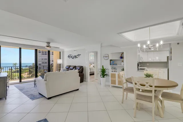 a living room with furniture and a view of kitchen