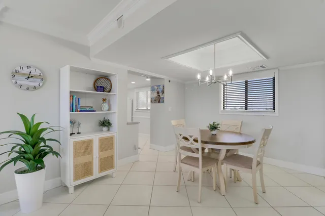 a bedroom with a large bed and a chandelier fan
