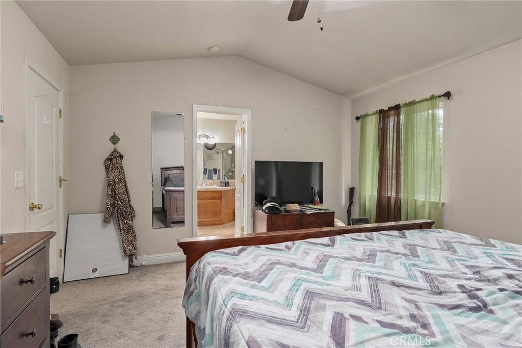 14689 Carnegie Road Magalia, CA 95954 - Photo 17 of 32 a bedroom with a bed and a flat tv screen on wall
