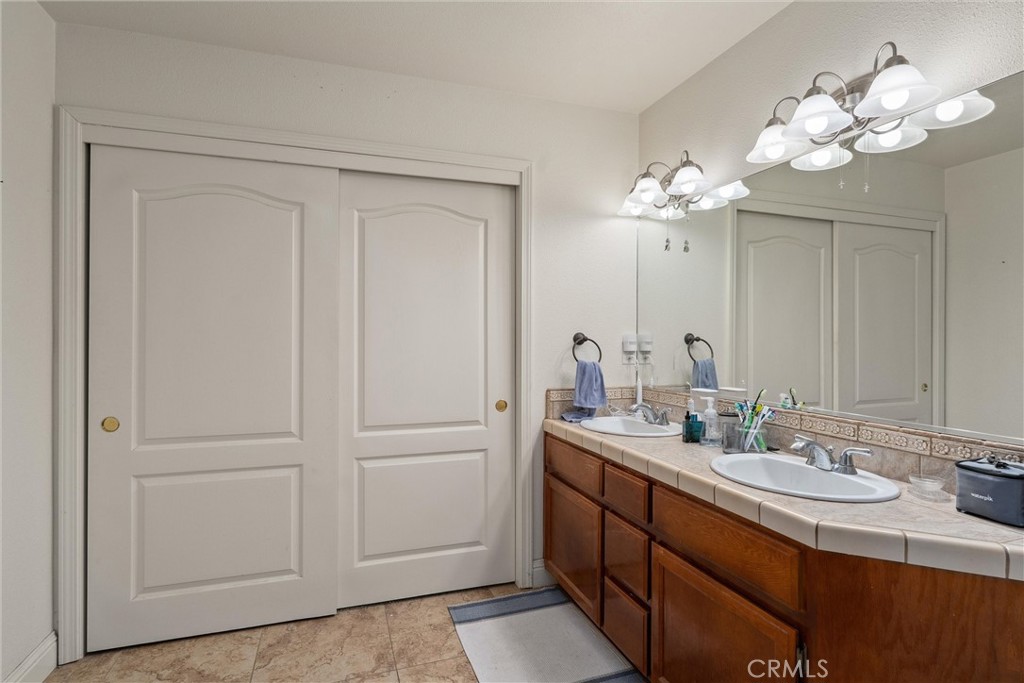 14689 Carnegie Road Magalia, CA 95954 - Photo 18 of 32 a bathroom with a double vanity sink and a mirror