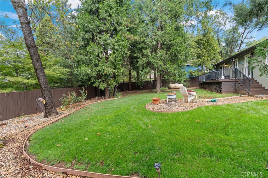 14689 Carnegie Road Magalia, CA 95954 - Photo 29 of 32 a view of a backyard with table and chairs and wooden fence