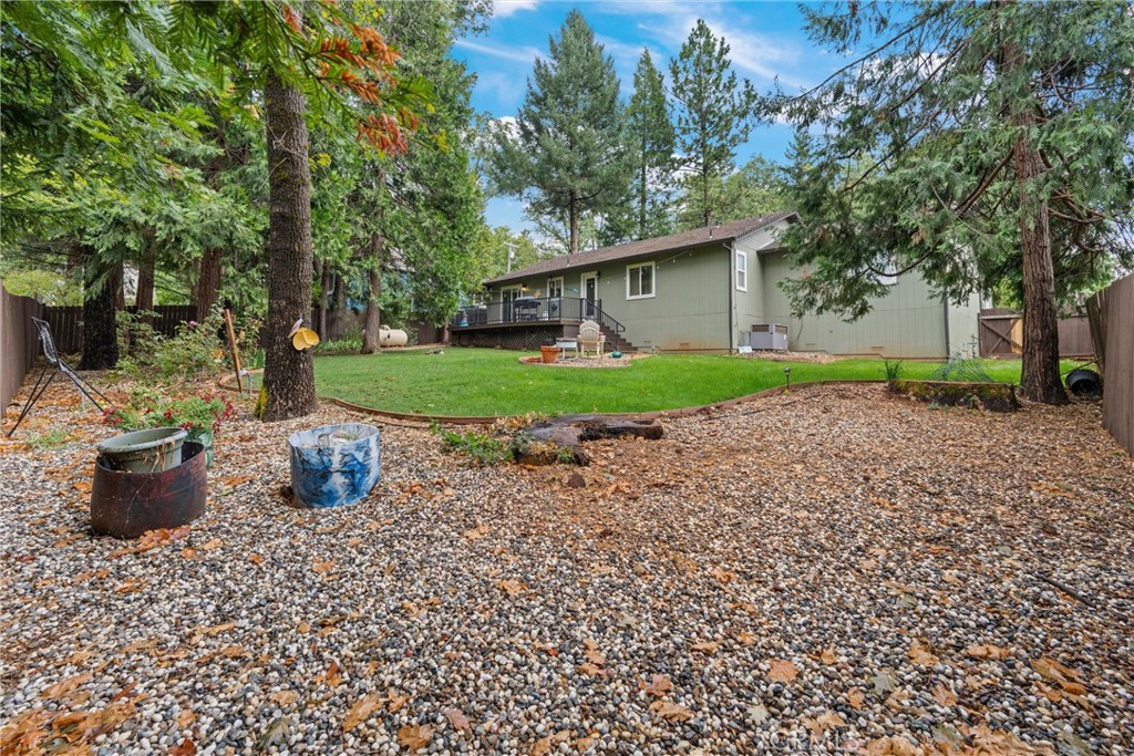 14689 Carnegie Road Magalia, CA 95954 - Photo 31 of 32 a view of a backyard with potted plants and large trees