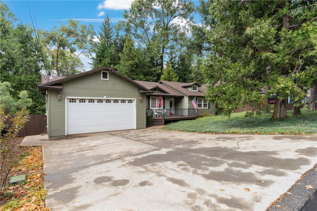 14689 Carnegie Road Magalia, CA 95954 - Photo 5 of 32 a view of a white house with a large tree in front of it