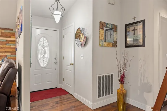 a view of an entryway with wooden floor