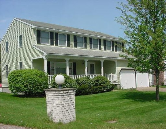 a front view of a house with garden and porch