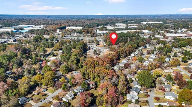 an aerial view of house with yard and mountain in all around