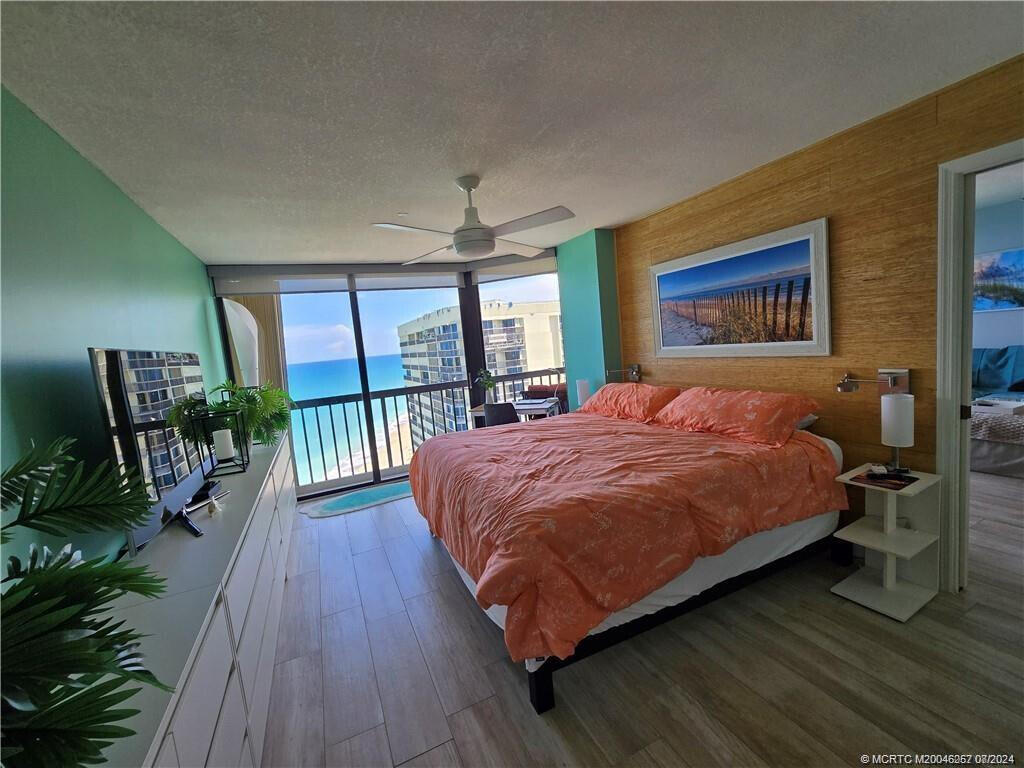 9500 South Ocean Drive, Unit 1908 Jensen Beach, FL 34957 - Photo 11 of 25 a large bedroom with a bed and large windows