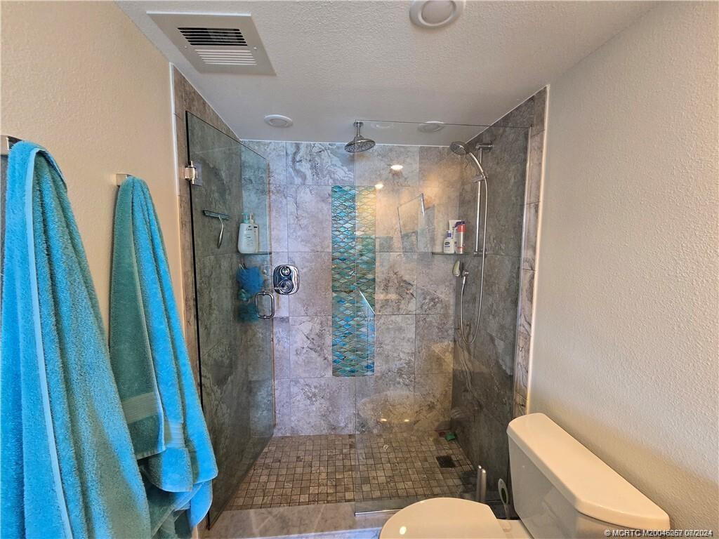 9500 South Ocean Drive, Unit 1908 Jensen Beach, FL 34957 - Photo 15 of 25 a bathroom with a shower a toilet and a sink