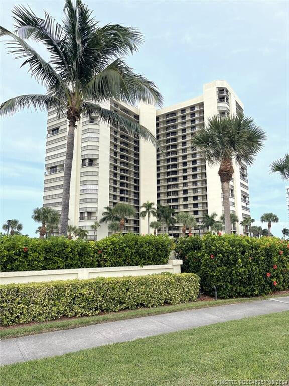 9500 South Ocean Drive, Unit 1908 Jensen Beach, FL 34957 - Photo 19 of 25 a front view of a multi story building with a yard