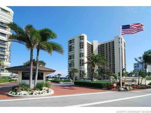 9500 South Ocean Drive, Unit 1908 Jensen Beach, FL 34957 - Photo 2 of 25 a front view of a building with palm trees