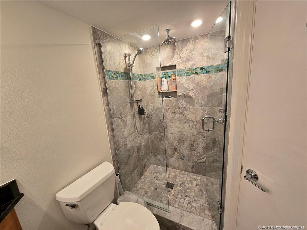 9500 South Ocean Drive, Unit 1908 Jensen Beach, FL 34957 - Photo 7 of 25 a bathroom with a shower a toilet and a sink