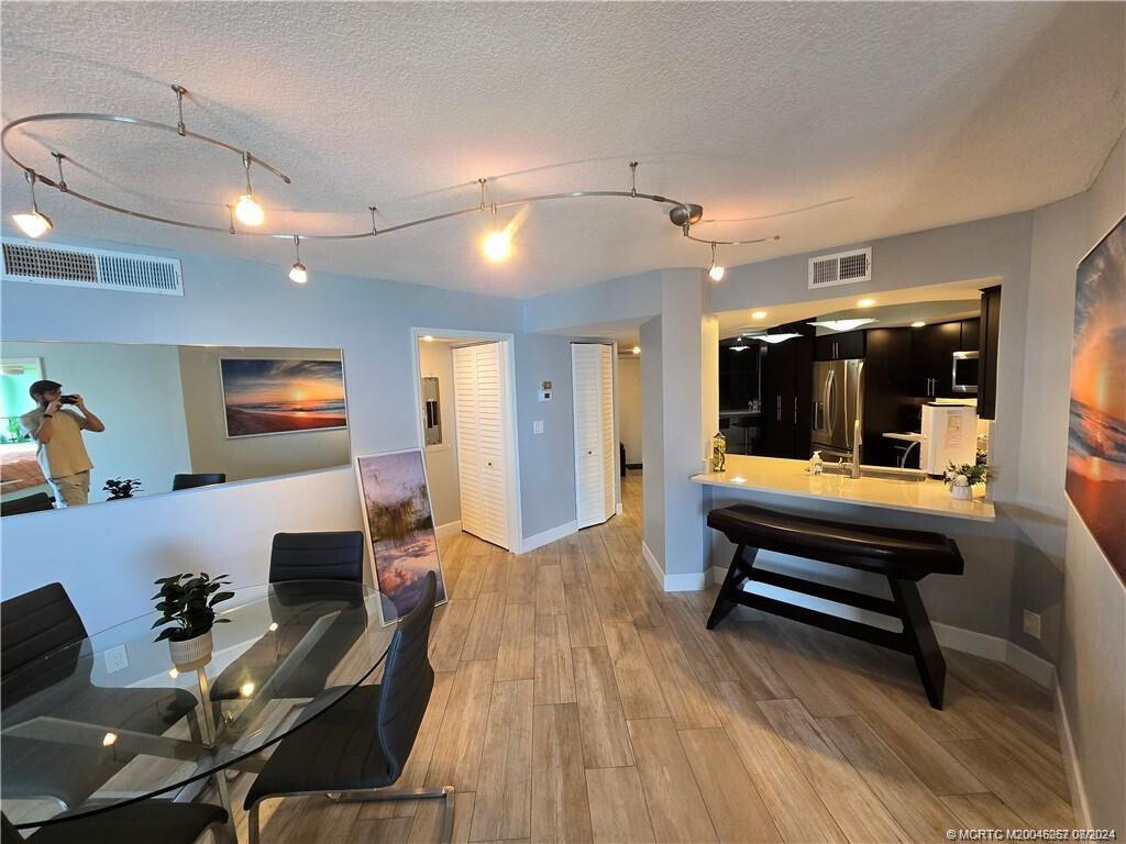 9500 South Ocean Drive, Unit 1908 Jensen Beach, FL 34957 - Photo 8 of 25 a living room with furniture and a flat screen tv