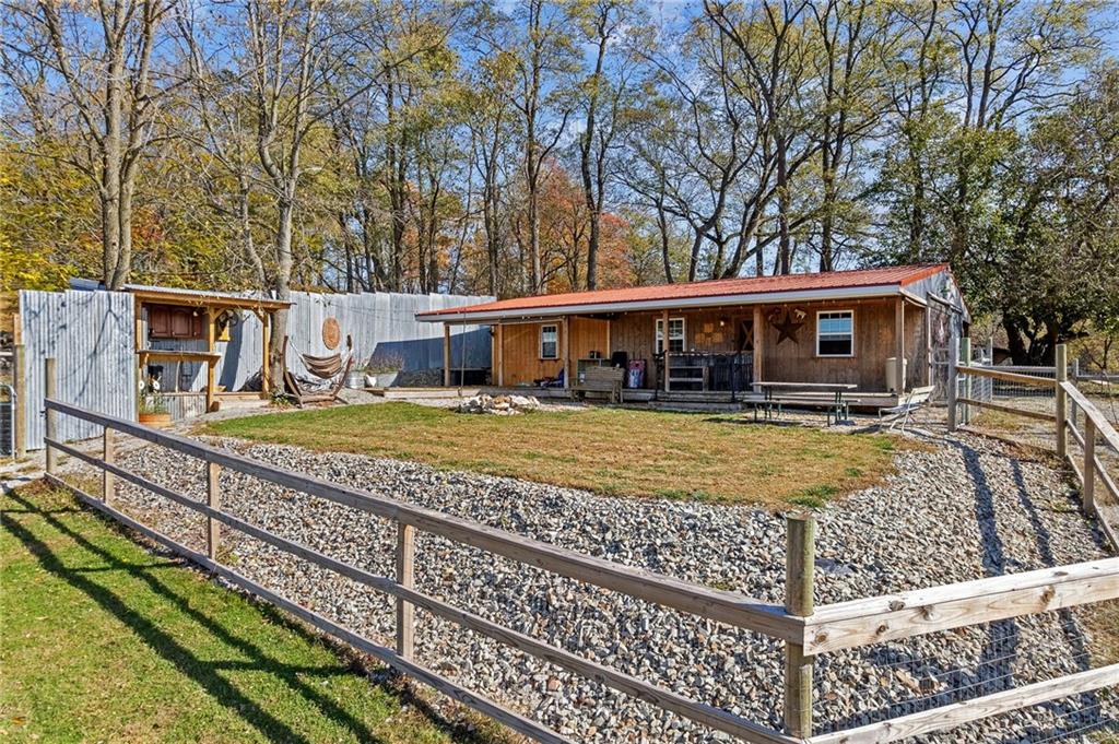1060 Sugar Run Road Finleyville, PA 15332 - Photo 31 of 50 Fenced in and equipped w/outdoor kitchen, fire pit, covered deck w/bar, 3 horse stalls and room able to convert to a 4th stall!