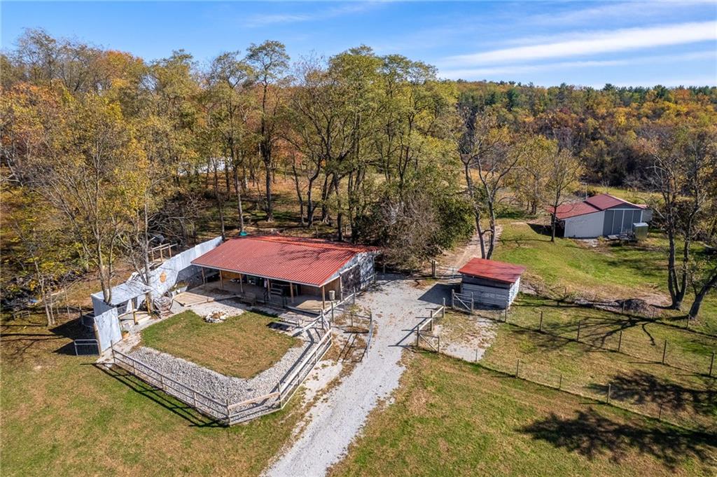 1060 Sugar Run Road Finleyville, PA 15332 - Photo 33 of 50 Fenced in and equipped w/outdoor kitchen, fire pit, covered deck w/bar, 3 horse stalls and room able to convert to a 4th stall!
