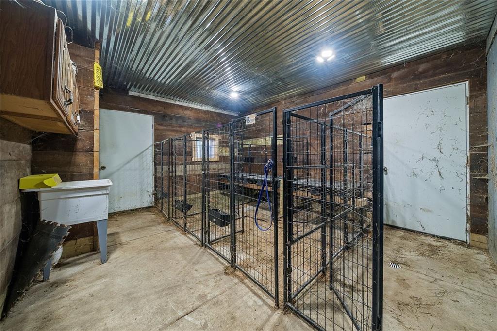 1060 Sugar Run Road Finleyville, PA 15332 - Photo 38 of 50 Fenced in and equipped w/outdoor kitchen, fire pit, covered deck w/bar, 3 horse stalls and room able to convert to a 4th stall!