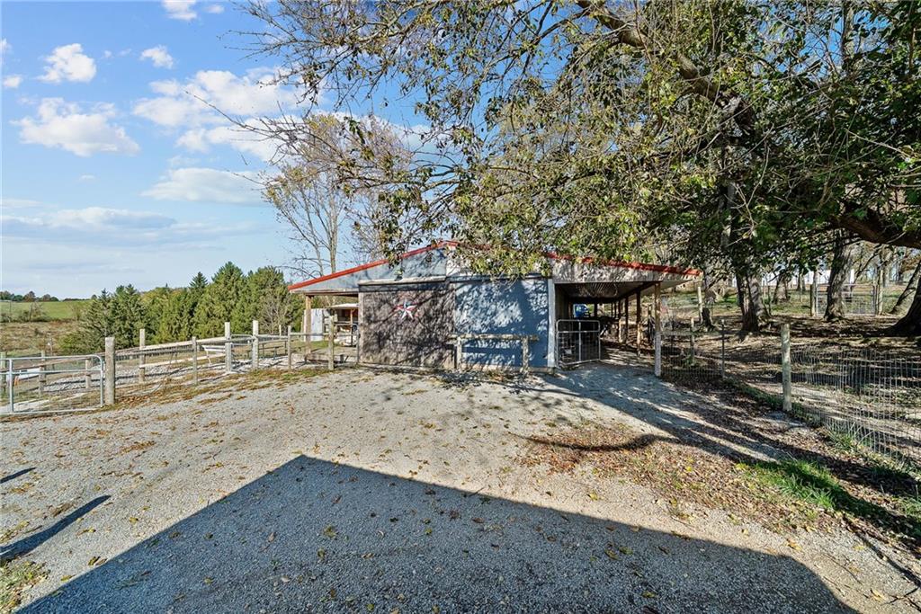 1060 Sugar Run Road Finleyville, PA 15332 - Photo 39 of 50 Fenced in and equipped w/outdoor kitchen, fire pit, covered deck w/bar, 3 horse stalls and room able to convert to a 4th stall!