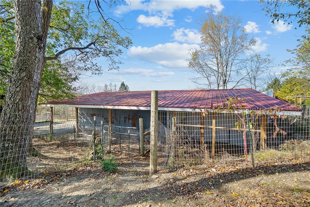 1060 Sugar Run Road Finleyville, PA 15332 - Photo 40 of 50 Fenced in and equipped w/outdoor kitchen, fire pit, covered deck w/bar, 3 horse stalls and room able to convert to a 4th stall!