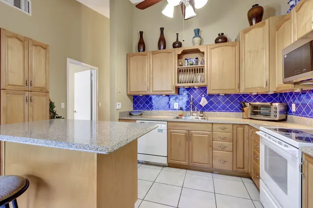 a kitchen with stainless steel appliances granite countertop a sink and cabinets