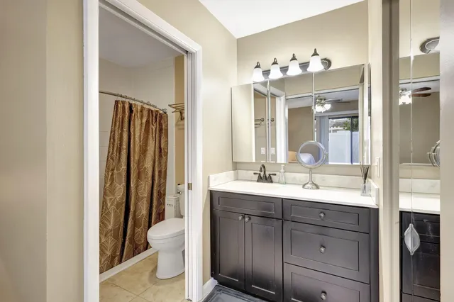 a bathroom with a shower curtain and a toilet