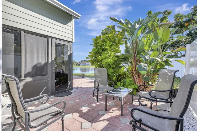 a backyard of a house with yard and outdoor seating