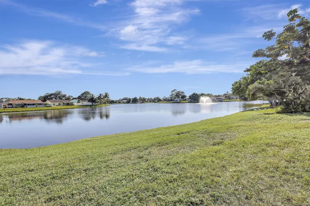 a view of a lake with houses in the background