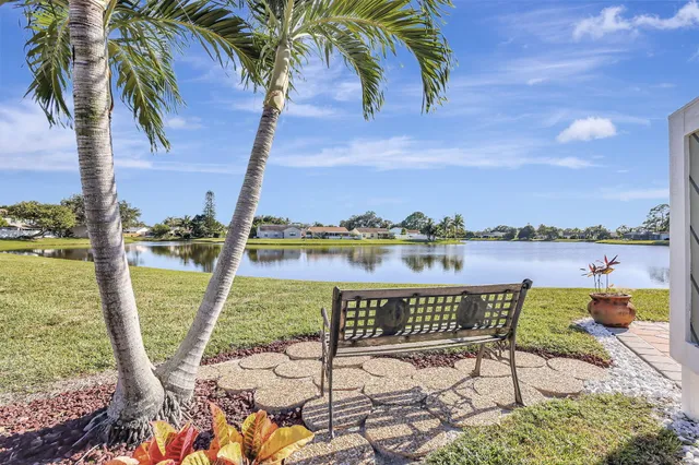 a view of a lake with a table and chairs