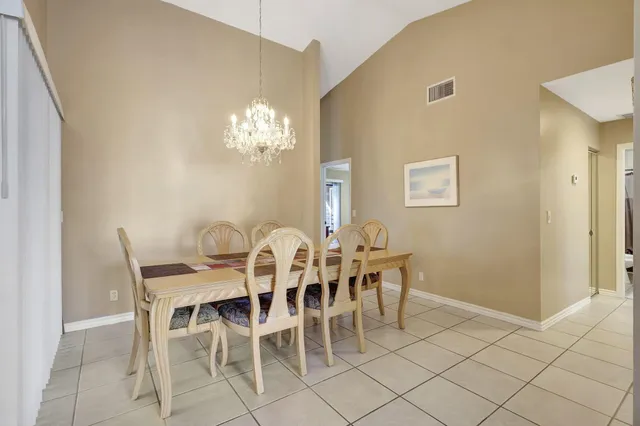 a view of a dining room with furniture and chandelier
