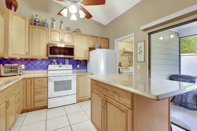 a kitchen with stainless steel appliances a stove refrigerator sink and microwave