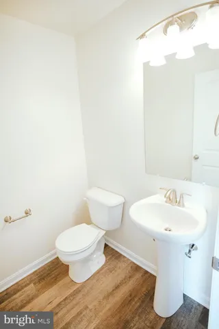 a bathroom with a toilet sink and a mirror