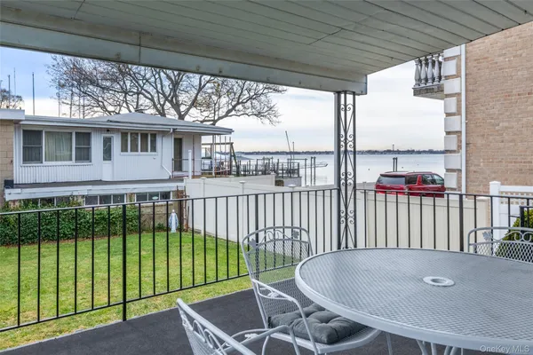 a balcony with table and chairs