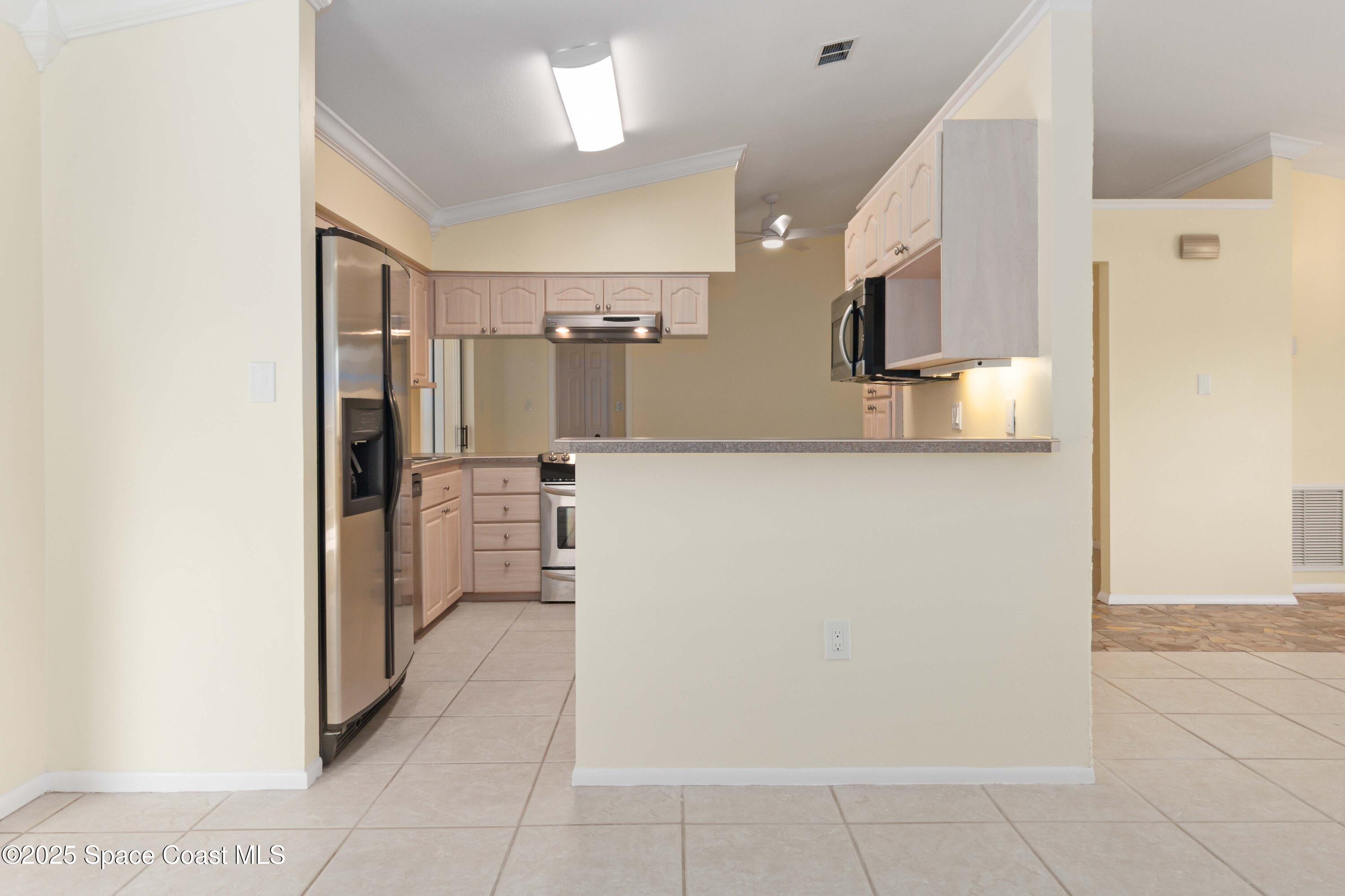 2355 Raintree Lake Circle Merritt Island, FL 32953 - Photo 14 of 47 a view of a hallway to a kitchen