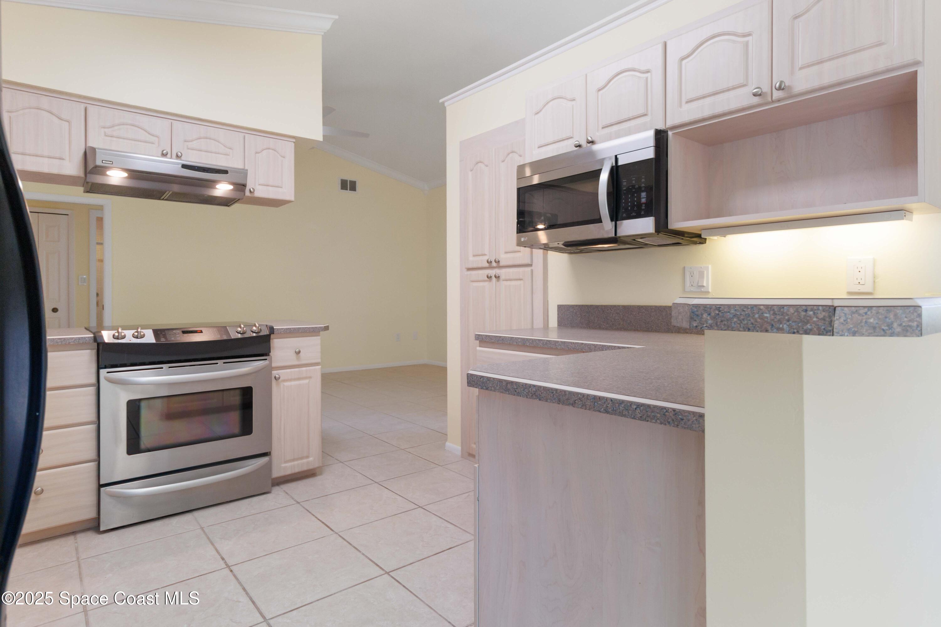 2355 Raintree Lake Circle Merritt Island, FL 32953 - Photo 15 of 47 a kitchen with granite countertop a sink and stainless steel appliances