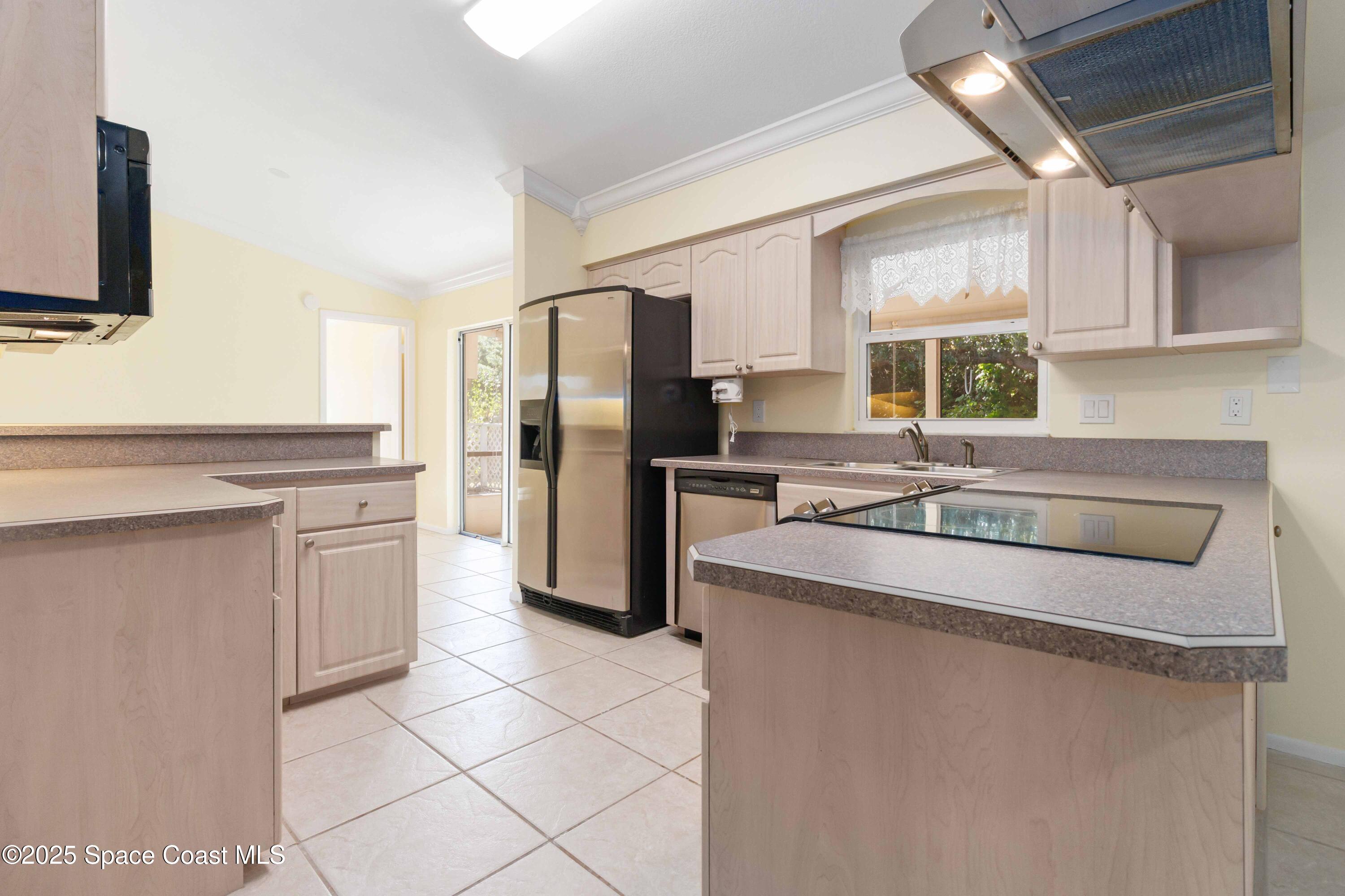 2355 Raintree Lake Circle Merritt Island, FL 32953 - Photo 16 of 47 a kitchen with a refrigerator sink and cabinets