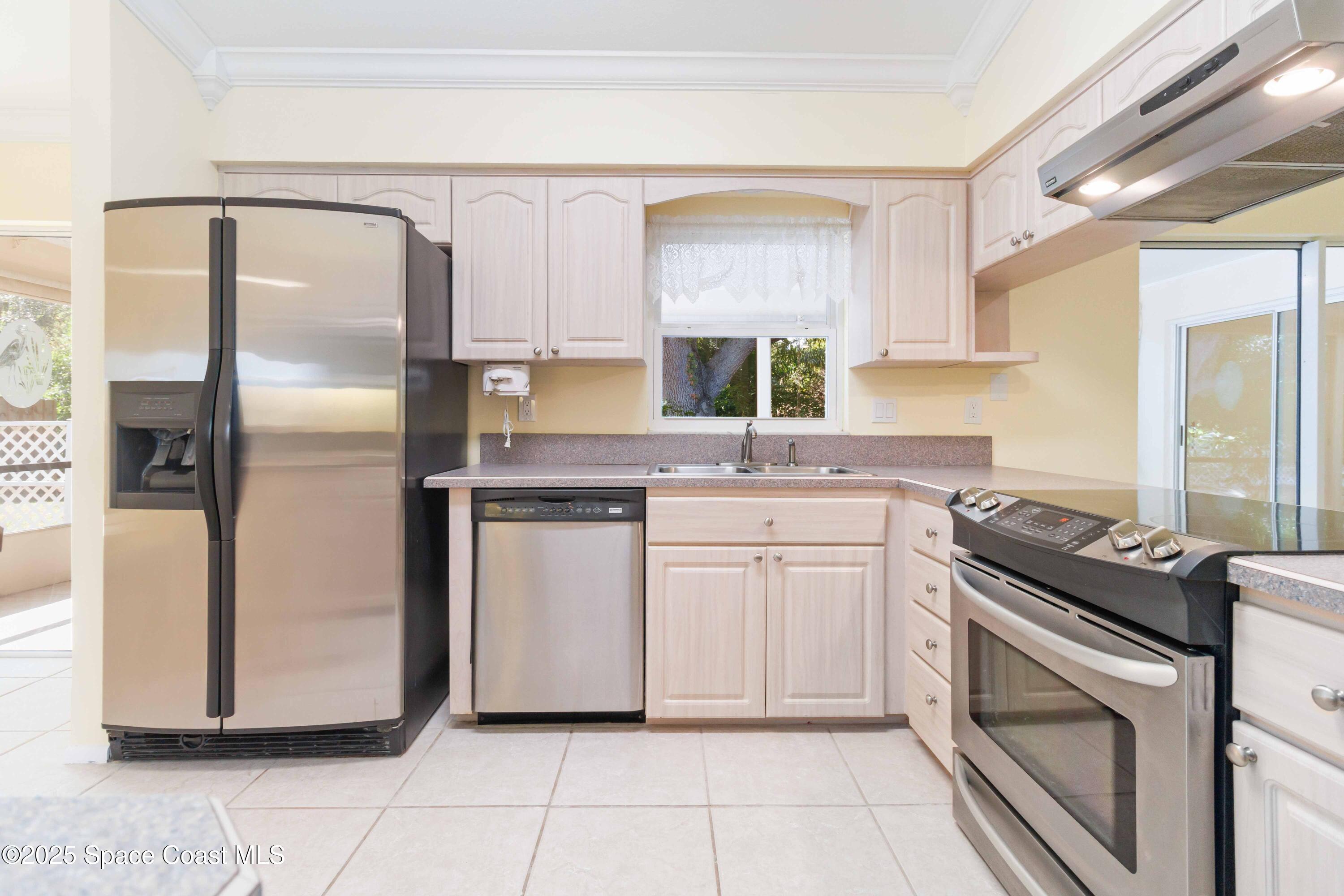 2355 Raintree Lake Circle Merritt Island, FL 32953 - Photo 17 of 47 a kitchen with white cabinets and white appliances