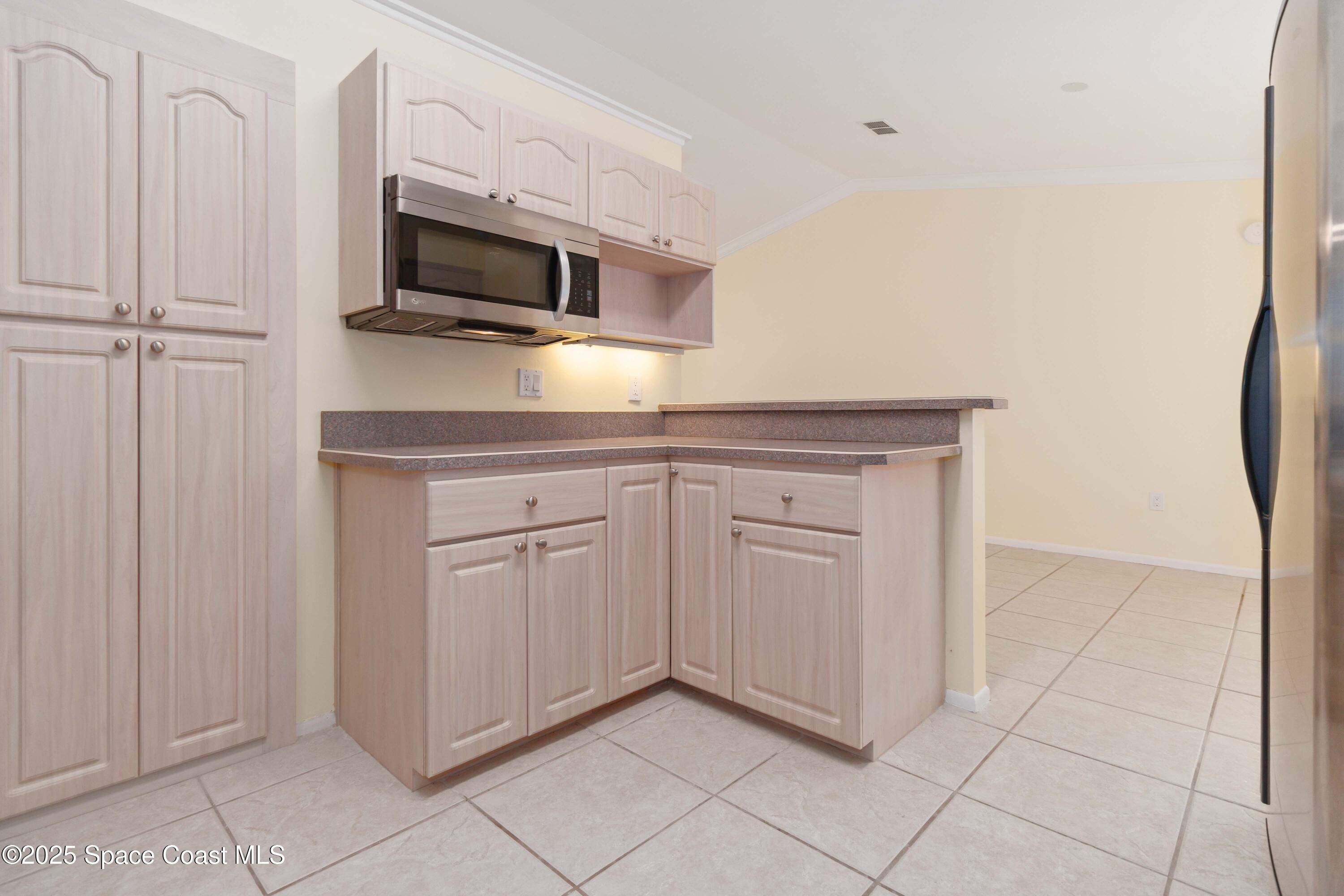 2355 Raintree Lake Circle Merritt Island, FL 32953 - Photo 18 of 47 a kitchen with white cabinets