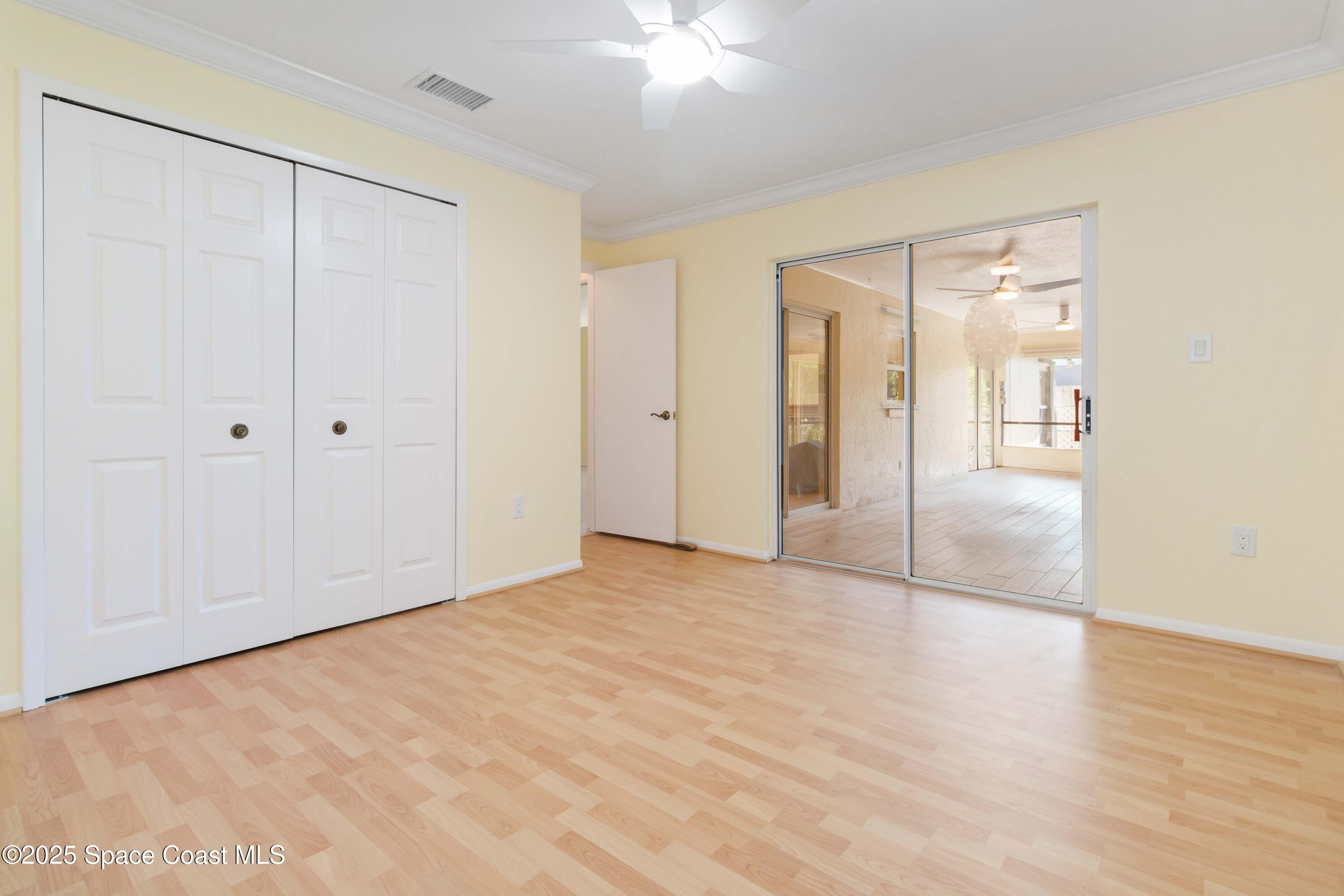 2355 Raintree Lake Circle Merritt Island, FL 32953 - Photo 26 of 47 a view of an empty room with wooden floor and a bathroom