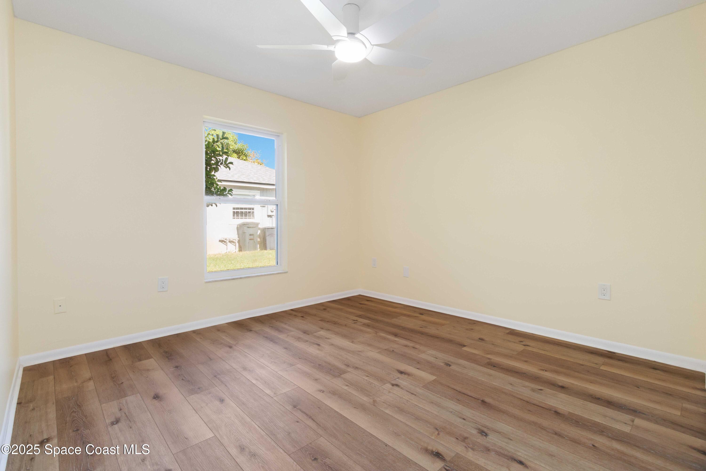 2355 Raintree Lake Circle Merritt Island, FL 32953 - Photo 27 of 47 an empty room with wooden floor cabinet and windows