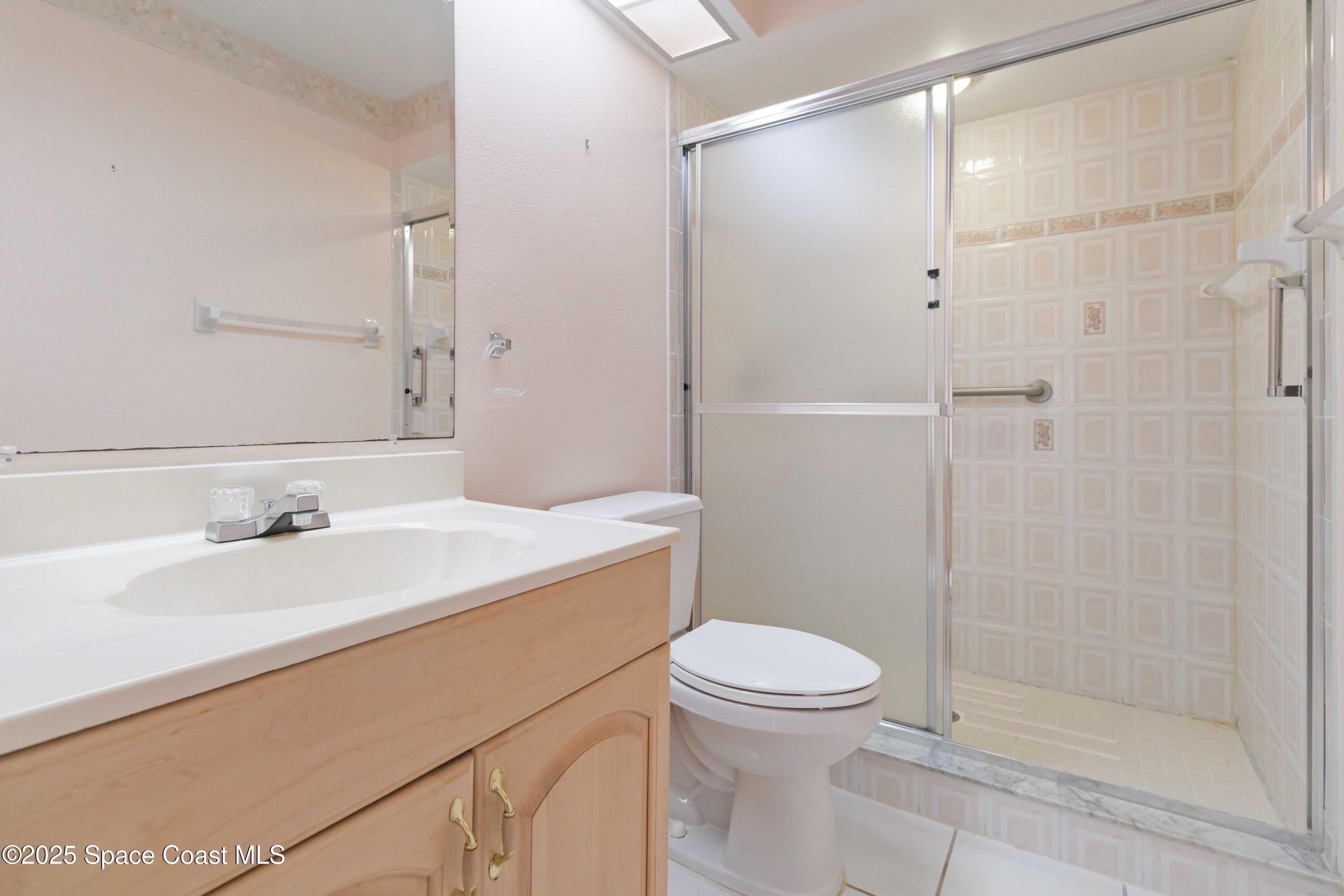 2355 Raintree Lake Circle Merritt Island, FL 32953 - Photo 29 of 47 a bathroom with a sink a toilet and shower