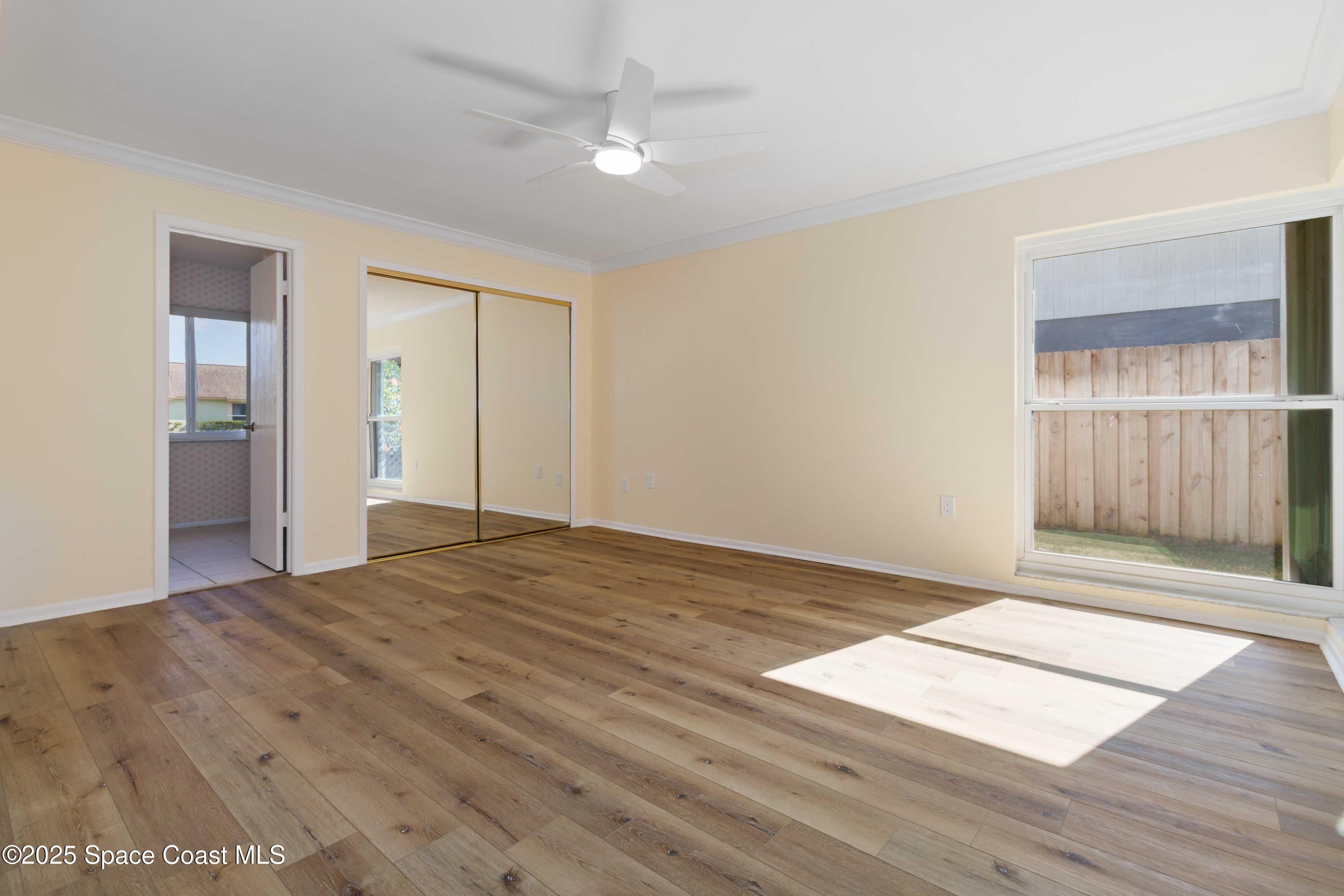 2355 Raintree Lake Circle Merritt Island, FL 32953 - Photo 30 of 47 a view of an empty room with wooden floor and a window