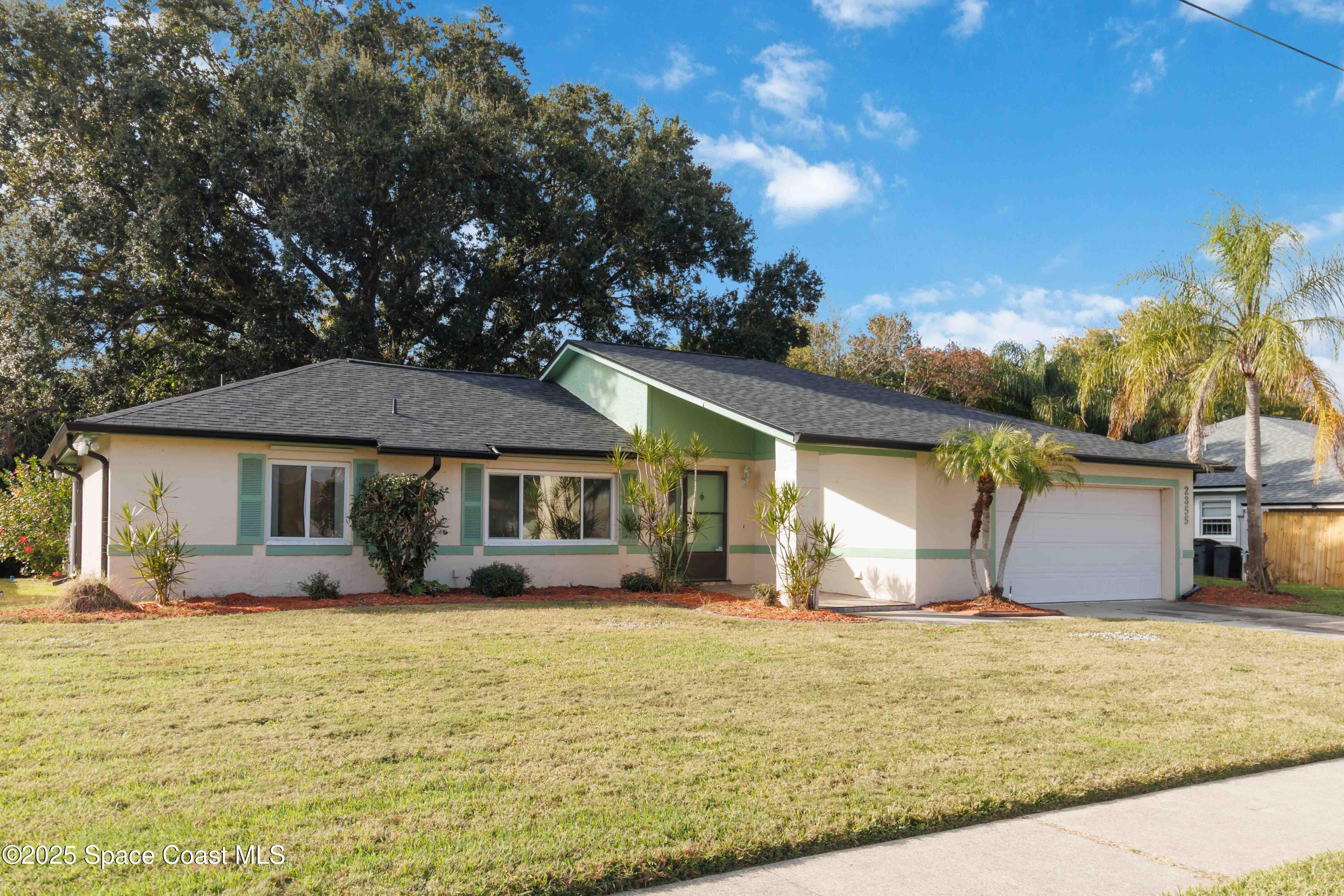 2355 Raintree Lake Circle Merritt Island, FL 32953 - Photo 3 of 47 a front view of a house with garden